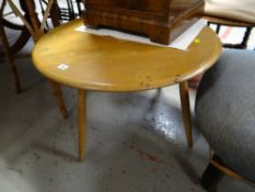 A lightwood Ercol circular coffee table