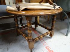 A good circular occasional table with turned stretchers & supports on four blocked caster feet