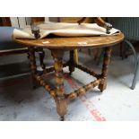 A good circular occasional table with turned stretchers & supports on four blocked caster feet