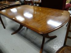 A reproduction twin-pedestal dining table