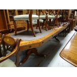 An excellent reproduction twin-pedestal extending dining table with two extra leaves in mahogany