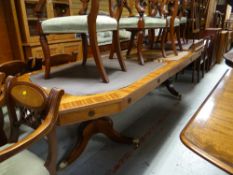 An excellent reproduction twin-pedestal extending dining table with two extra leaves in mahogany