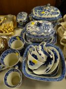A quantity of antique willow patterned pottery including covered tureens, platters etc
