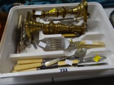 A pair of brass candlestick holders & sundry loose cutlery