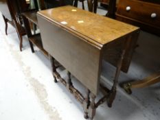 A delicate antique reproduction gate leg table