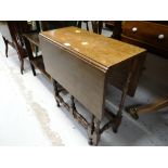 A delicate antique reproduction gate leg table