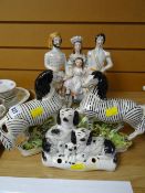 A good group of nineteenth century Staffordshire ornaments including a pair of zebra models, a