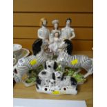 A good group of nineteenth century Staffordshire ornaments including a pair of zebra models, a