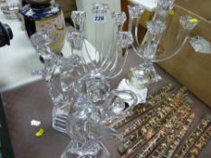 Pair of contemporary glass candleholders and candles, two glass dancing group sculptures