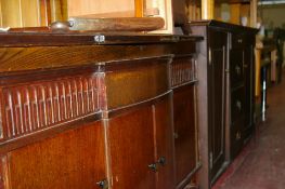 Oak bow fronted low sideboard and a reproduction mahogany effect sideboard base