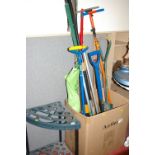 Quantity of long handled garden tools and a storage stand