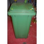 Large green wheelie bin and plant pot contents