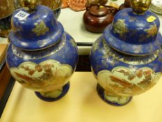 Pair of blue and gilt coloured Oriental lidded vases