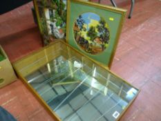 Glass shelved and fronted hanging display rack and two framed woolwork pictures