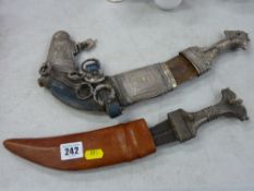 Two sheathed Arabic daggers