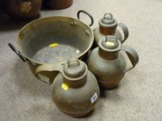 Three copper jugs and a brass jam pan with iron handle