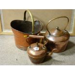 Two copper kettles and a beaten copper helmet coal scuttle with brass handle