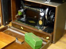 Cased Singer sewing machine with Singer box of accessories and a Singer oil can