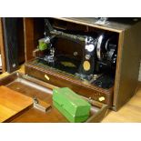 Cased Singer sewing machine with Singer box of accessories and a Singer oil can