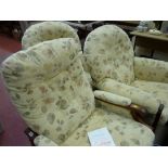 Pair of floral decorated armchairs and a similarly upholstered reclining chair by Cintique