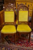A SET OF FOUR OAK GOTHIC STYLE SIDE CHAIRS with arched top pierced back rail and lower frieze,