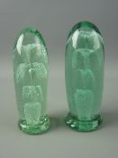 TWO VICTORIAN BULLET SHAPED GREEN GLASS DUMP PAPERWEIGHTS having potted multi-tier floral