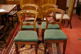 A SET OF FOUR VICTORIAN MAHOGANY DINING CHAIRS, the top rail with scroll ends, carved central rail