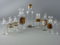 A PARCEL OF NINE CHEMIST'S PLAIN GLASS BOTTLES, various sizes, some with worn Latin labels