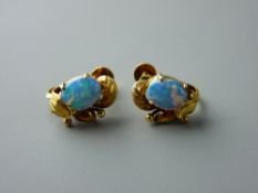 A PAIR OF FOURTEEN CARAT GOLD OPAL SET STUD EARRINGS, each having an oval cabochon opal, 8.7 x 6.5