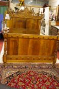 A PAIR OF VINTAGE EUROPEAN WALNUT 4ft 6ins BED ENDS with connecting irons, the headboard with carved