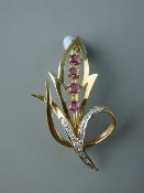 A NINE CARAT GOLD LEAF BROOCH set with tiny diamonds and four round cut pink stones, 4 grms gross