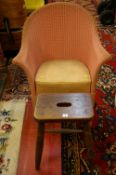 A LLOYD LOOM STYLE PAINTED ARMCHAIR and a vintage oak stool, 71 cms wide the armchair