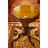 A VICTORIAN WALNUT WORK TABLE, the lidded top opening to reveal a sectional interior with central