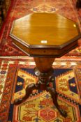 A VICTORIAN WALNUT WORK TABLE, the lidded top opening to reveal a sectional interior with central