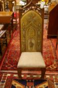 AN OAK GOTHIC STYLE HALL CHAIR with pierced and carved top rail, the tapestry back with knight in