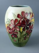 A MOORCROFT SPRING FLOWERS WALTER MOORCROFT SIGNED OVOID VASE, decorated on a tonal green ground,