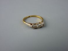 AN EIGHTEEN CARAT GOLD & PLATINUM THREE STONE DIAMOND ENGAGEMENT RING, size 'O'