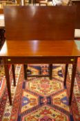 AN OBLONG TOPPED LATE 19th CENTURY MAHOGANY FOLDOVER TEA TABLE, having inlaid decoration to the