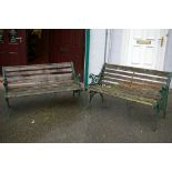 A PAIR OF 20th CENTURY GARDEN BENCHES with cast iron ends and slatted seats, 64.5 x 128 cms