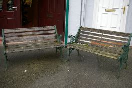 A PAIR OF 20th CENTURY GARDEN BENCHES with cast iron ends and slatted seats, 64.5 x 128 cms
