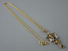 A NINE CARAT GOLD PENDANT NECKLACE having a fine link chain, the scrolled heart shaped pendant set