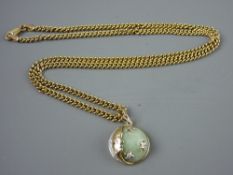 A NINE CARAT GOLD NECKLACE & PENDANT, set with a circular celadon jade stone with moon and star