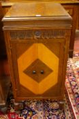 AN OAK EX-GRAMOPHONE CABINET by Edison Bell, having a lidded top and twin inlaid lower doors on