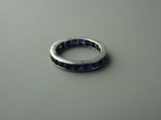 AN EIGHTEEN CARAT WHITE GOLD FULL ETERNITY SAPPHIRE RING having approximately twenty five square