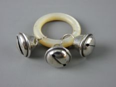 A BABY'S TEETHING RING with three silver bells, Chester 1907 on mother of pearl