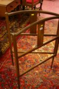A SHAPED EDWARDIAN MAHOGANY FOLDING LINEN AIRER, the curved top over a central splat, string inlaid,