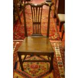 A CIRCA 1800 OAK FARMHOUSE CHAIR with shaped top rail and pierced splatback, on square supports with