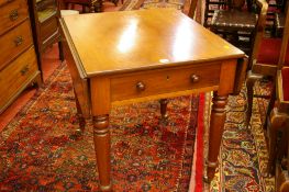 A VICTORIAN MAHOGANY PEMBROKE TABLE having twin drop flaps and single side drawer with turned wooden