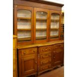 A NORTH WALES VICTORIAN OAK & MAHOGANY GLASS TOP BREAKFRONT DRESSER, the shaped cornice over a block