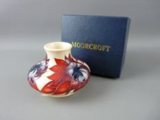 A MOORCROFT 'RUBY RED' SQUAT VASE, designed by Emma Bossons, decorated on a cream ground,
